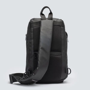 Black backpack with a gray back panel on a light gray background