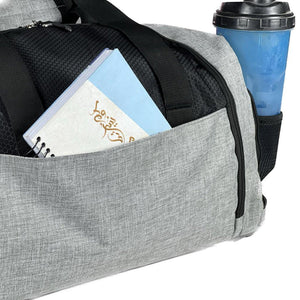 The bag is designed to be carried using two handles or a shoulder strap and is often used for sports or travel.