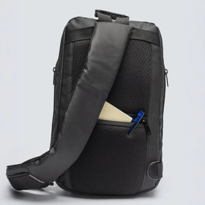 Black backpack with a visible zipper pocket on a light gray background