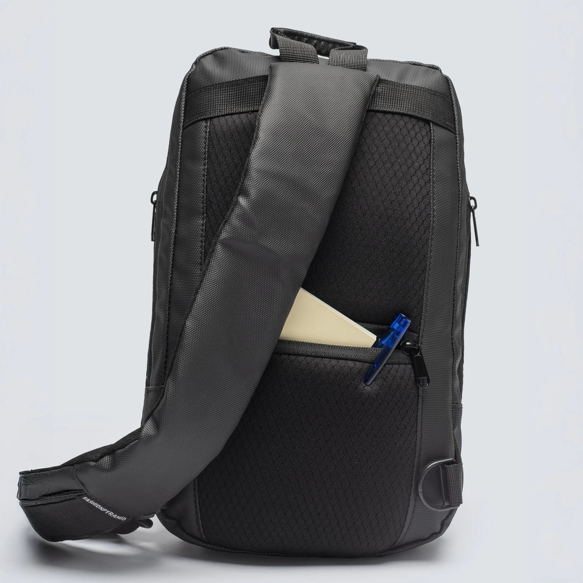 Black backpack with a visible zipper pocket on a light gray background