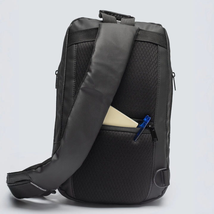 Black backpack with a visible zipper pocket on a light gray background